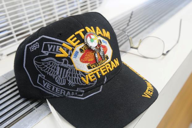 A Vietnam veteran's trucker hat with a Native American pin