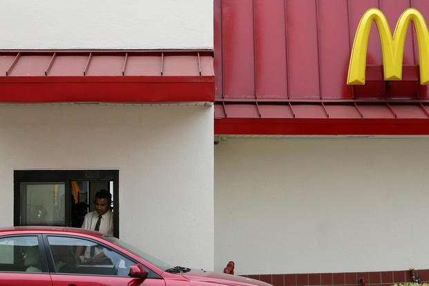 A McDonald's employee gives a customer food at the drive-thru window at a McDonald's restaurant in San Francisco