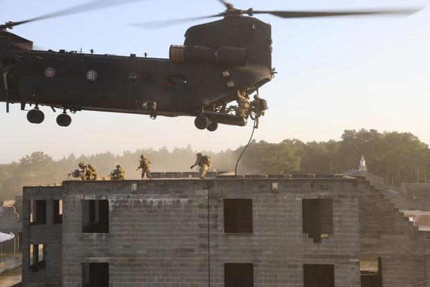 Soldiers conduct a fast rope onto a building during training exercise. 