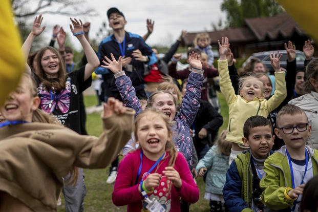 Children dance at the recovery camp for children and their mothers affected by the war near Lviv
