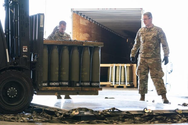 Airmen with the 436th Aerial Port Squadron place 155 mm shells on aircraft pallets