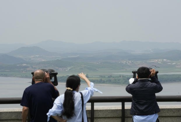 Visitors watch the North Korea side from the Unification Observation Post in Paju, South Korea