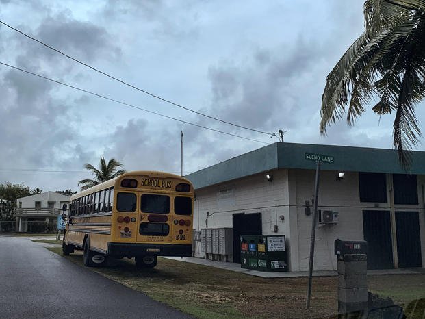 A school bus waits to transport residents in Guam, ahead of Typhoon Mawar. 