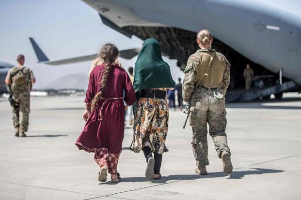Marine with children during evacuation at Hamid Karzai International Airport, Kabul.