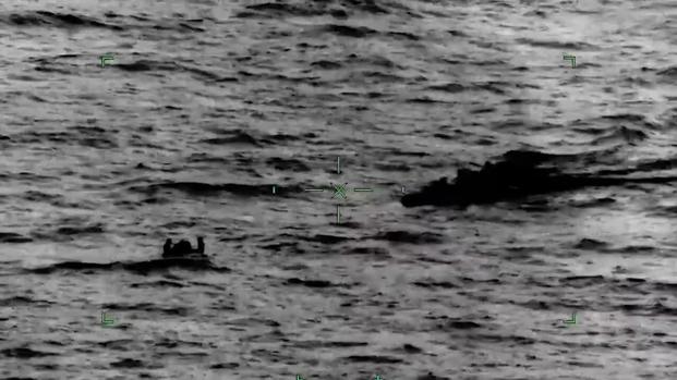 An image from a video shows the Coast Guard and Navy rescuing 4 divers about 50 miles southeast of North Carolina’s Cape Fear River.