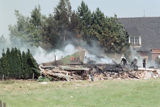 The tail of a Soviet MiG-23 combat plane rises from the rubble after it crashed into a house in Bellegem, Belgium, July 4, 1989. 