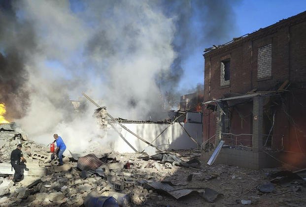 People work to extinguish a fire following a Russian attack in Kryvyi Rih, Ukraine.
