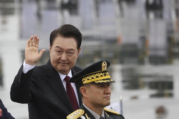South Korean President Yoon Suk Yeol waves to the crowd