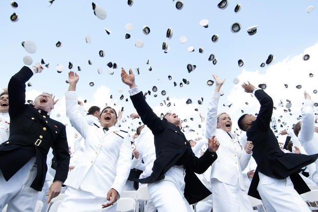 Newly commissioned officers of the U.S. Navy and Marine Corps toss their midshipmen covers in the air at the end of the Class of 2014 graduation ceremony at Annapolis, Md. 