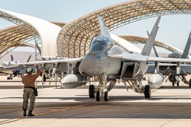 An F/A-18 Hornet assigned to the “Vampires” of Air Test and Evaluation Squadron Nine (VX-9) taxis into a stall at Naval Air Weapons Station China Lake (NAWSCL) following flight operations.
