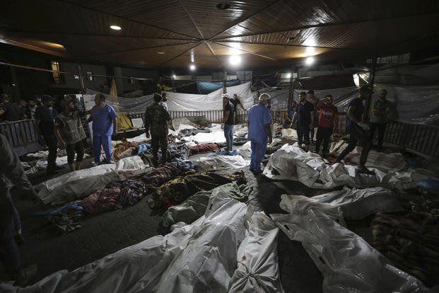 Bodies of Palestinians killed by an explosion at the Ahli Arab hospital