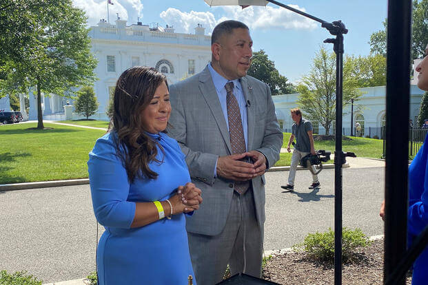 Former Army Capt. Le Roy Torres, pictured with his wife Rosie following the signing of the PACT Act in August 2022, won a lawsuit Friday against the state of Texas for his dismissal for a service-related health condition. 