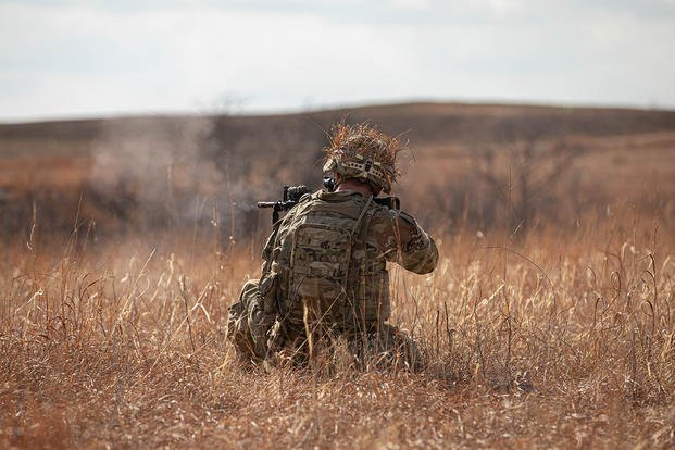 An Oklahoma Army National Guard soldier with Bravo Company, 1st Battalion, 179th Infantry Regiment, 45th Infantry Brigade Combat Team, fires his M4 Carbine during a live fire squad training exercise at Fort Riley, Kansas.