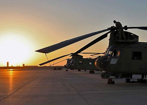 U.S. Army soldiers conduct preflight checks on CH-47 Chinooks