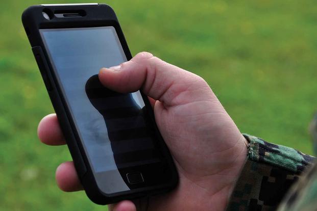 A Marine on Camp Hansen tests a cell phone app