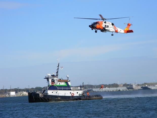  A Coast Guard MH-60 Jayhawk crew lowers a rescue swimmer to the towing vessel Elizabeth Anne during the 14th annual Towing Vessel Safety Seminar Nov. 8, 2012 at Coast Guard Sector Hampton Roads.