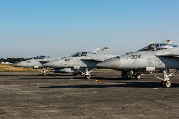 Cdr. Neal Young (left), Lt. Garrett Sherwood (center), Cdr. Christopher Williams (right) of Strike Fighter Squadron 115 (VFA-115) Eagles depart Naval Air Facility Atsugi (NAF) in F/A-18E Super Hornets Dec. 1.
