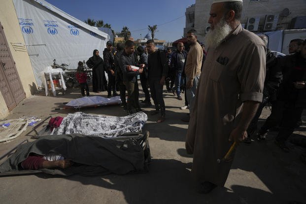 Palestinians gather around their relatives killed in the Israeli bombardment of the Gaza Strip.