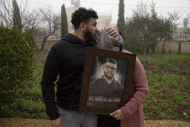 Amir Abdel Jabbar, whose younger brother Tawfic was fatally shot, comforts their mother, Mona