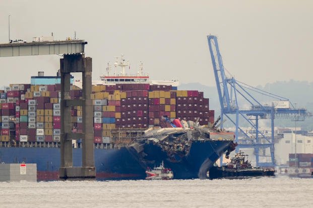 Tugboats escort the cargo ship Dali after it was refloated in Baltimore