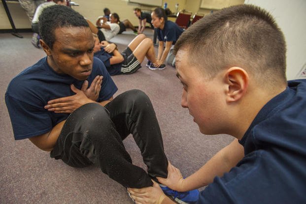 Tyler M. Martin, left, and Richard J. Weaver, both members of the 108th Wing Student Flight, perform the push-up portion of the physical fitness test April 13, 2013, at the National Guard Training Center in Sea Girt, N.J. 