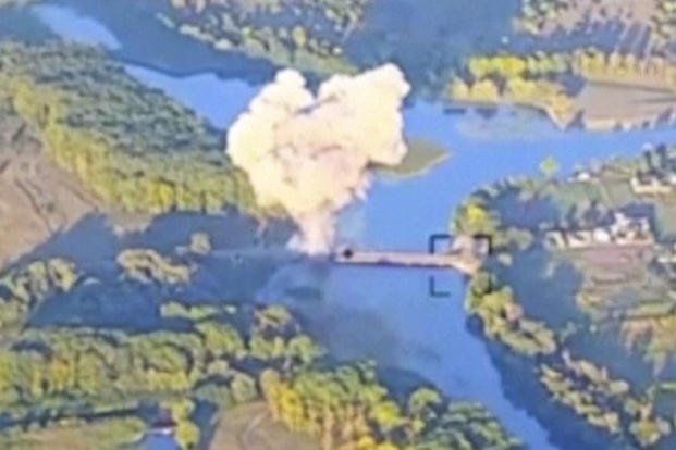 In this footage released by the Ukrainian armed forces on Sunday, Aug. 18, 2024, smoke billows in what is said to show the destruction of a key bridge in Russia's Kursk region.