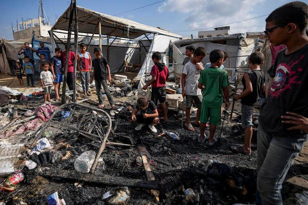 Palestinians inspect the damage at a tent area in the courtyard of Al Aqsa Martyrs hospital