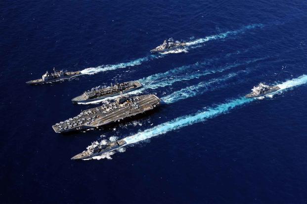 Abraham Lincoln Carrier Strike Group ships cruise in formation