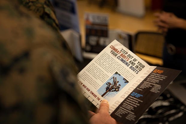 U.S. Marine reads a pamphlet during a SkillBridge expo