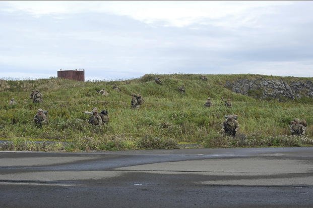 U.S. Army soldiers maneuver through the thick terrain of Shemya Island, Alaska