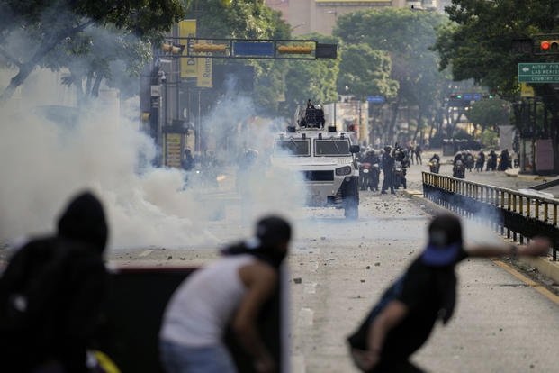 Protesters clash with police during demonstrations in Caracas, Venezuela