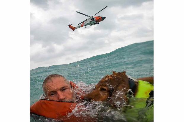 Coast Guard Air Station Clearwater helicopter crew rescues a man and his dog