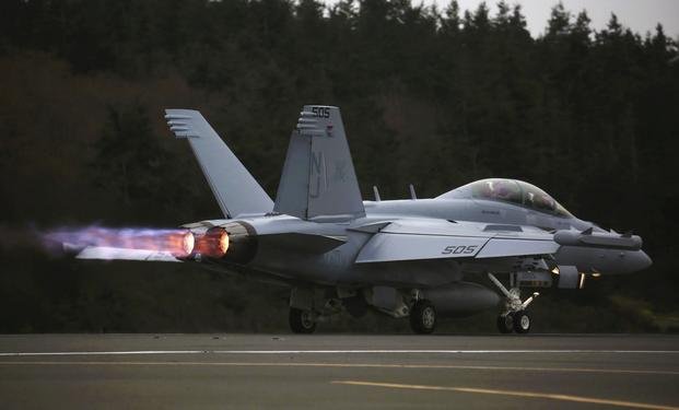 An EA-18G Growler engine's thrust with afterburner propels its takeoff from Naval Air Station Whidbey Island