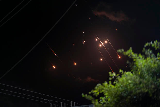 Missiles launched from Iran towards Israel streak across the night sky