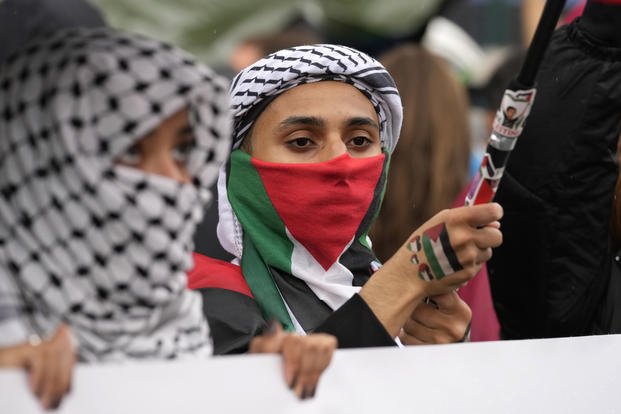 Women attend at a protest in Rome, Saturday, Oct. 5, 2024. 