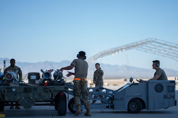 U.S. Air Force maintenance unit load munitions onto a jammer