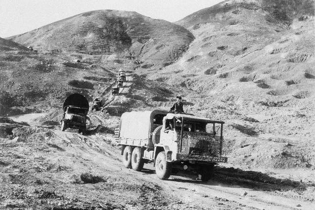 A truck supply convoy heads toward the Mu Gia pass into Laos along Route 12 in the Ha Tinh province of Vietnam in 1968. 