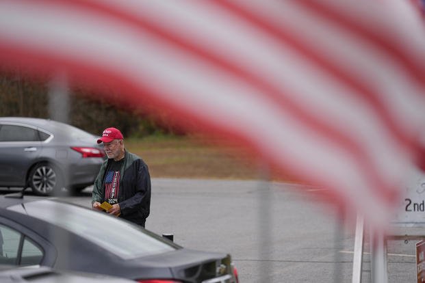 Sam Hopkins campaigns for the Republican ticket near a polling place on Nov. 5, 2024, in Canton, North Carolina. (AP Photo/George Walker IV)