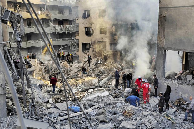 Rescue workers search for victims at the site of an Israeli airstrike in Beirut, Lebanon.