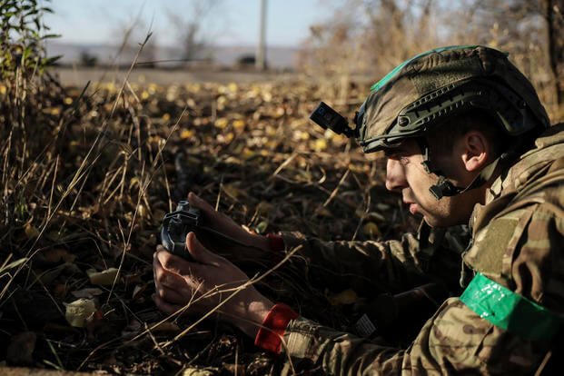 An Ukraine service member installs land mines along the frontlines.