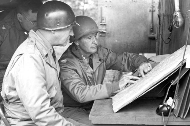 Col. Geoffrey Keyes, right, and Gen. George S. Patton look over a map in field headquarters during army maneuvers in South Carolina in 1941 during World War II. 