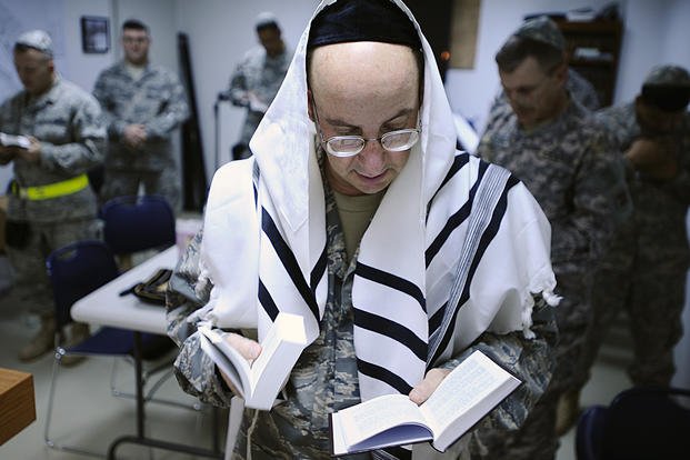 Capt. Andrew Cohen leads the Sabbath evening worship during the 6th day of Hanukkah at Joint Base Balad, Iraq.