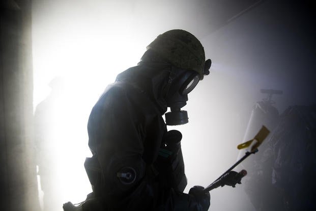 A member of the Japan Ground Self-Defense Force’s 102nd Central Nuclear Biological Chemical Weapon Defense Unit makes his way through a smoke-filled room inside the fire training tower aboard Marine Corps Air Station Iwakuni, Japan.