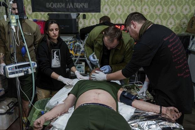 A medic treats an injured Ukrainian serviceman at Medical Service "Ulf"