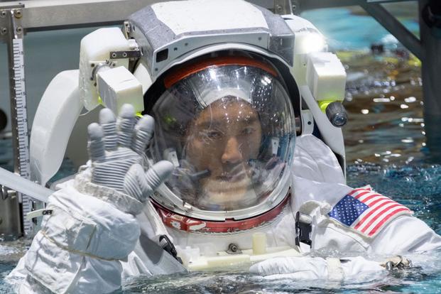 2017 NASA astronaut candidate Jonny Kim is lowered into the training pool for spacewalk training at NASA Johnson Space Center’s Neutral Buoyancy Laboratory in Houston. (Robert Markowitz/NASA)