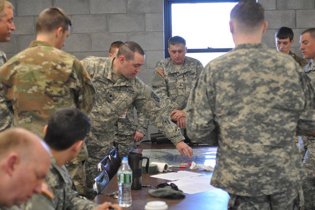 U.S. Army soldiers who specialize in military intelligence give a briefing during low-density military occupational specialty (MOS) training at Camp Ethan Allen Training Site, Jericho, Vermont.