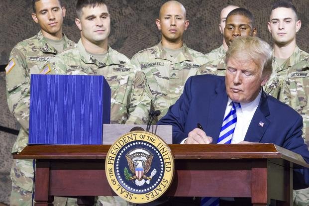 President Donald J. Trump signs the National Defense Authorization Act of 2019 at Fort Drum, New York, on August 13. (U.S. Army photo by Sgt. Thomas Scaggs) 