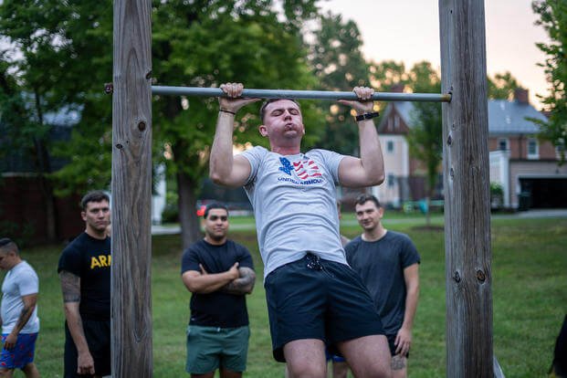 A soldier from the 3d U.S. Infantry Regiment (The Old Guard) conducts a pull-up during the unit’s ‘TOG Week’ on Fort Belvoir, Virginia.