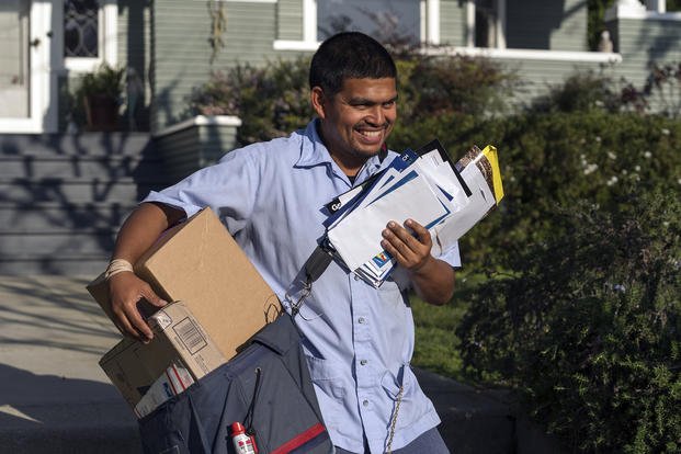 U.S. Postal Service letter carrier Gabriel Peña carries mail in Los Angeles.