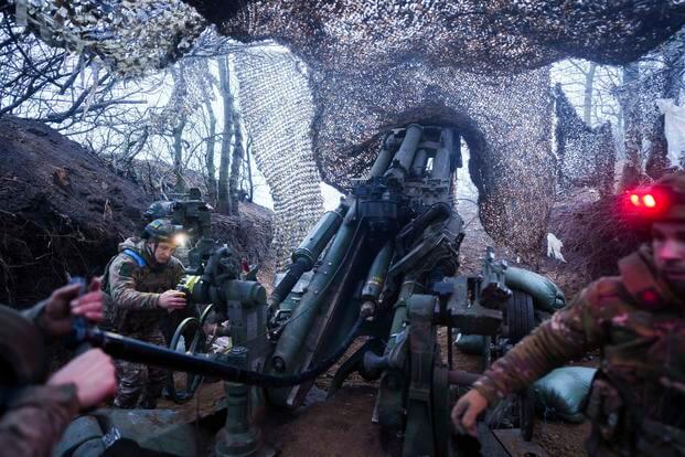 Ukrainian servicemen of 148th artillery brigade fire by a M777 howitzer towards Russian positions